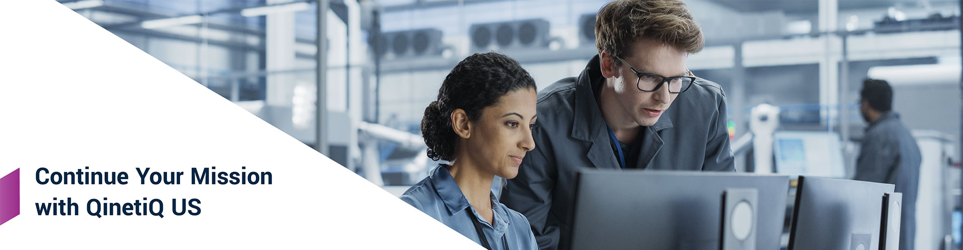 2 employees in an office looking at a computer screen