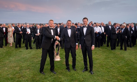 Two representatives of Pilatus Aircraft Ltd (Thomas Syfrig and Bruno Schmid) presenting the Commanding Officer at ETPS, Cdr Ian Houlston RN, with a Swiss cow bell. In addition to celebrating the 80th anniversary of the school, the gift also symbolises five years of strong collaboration between the school and Pilatus.