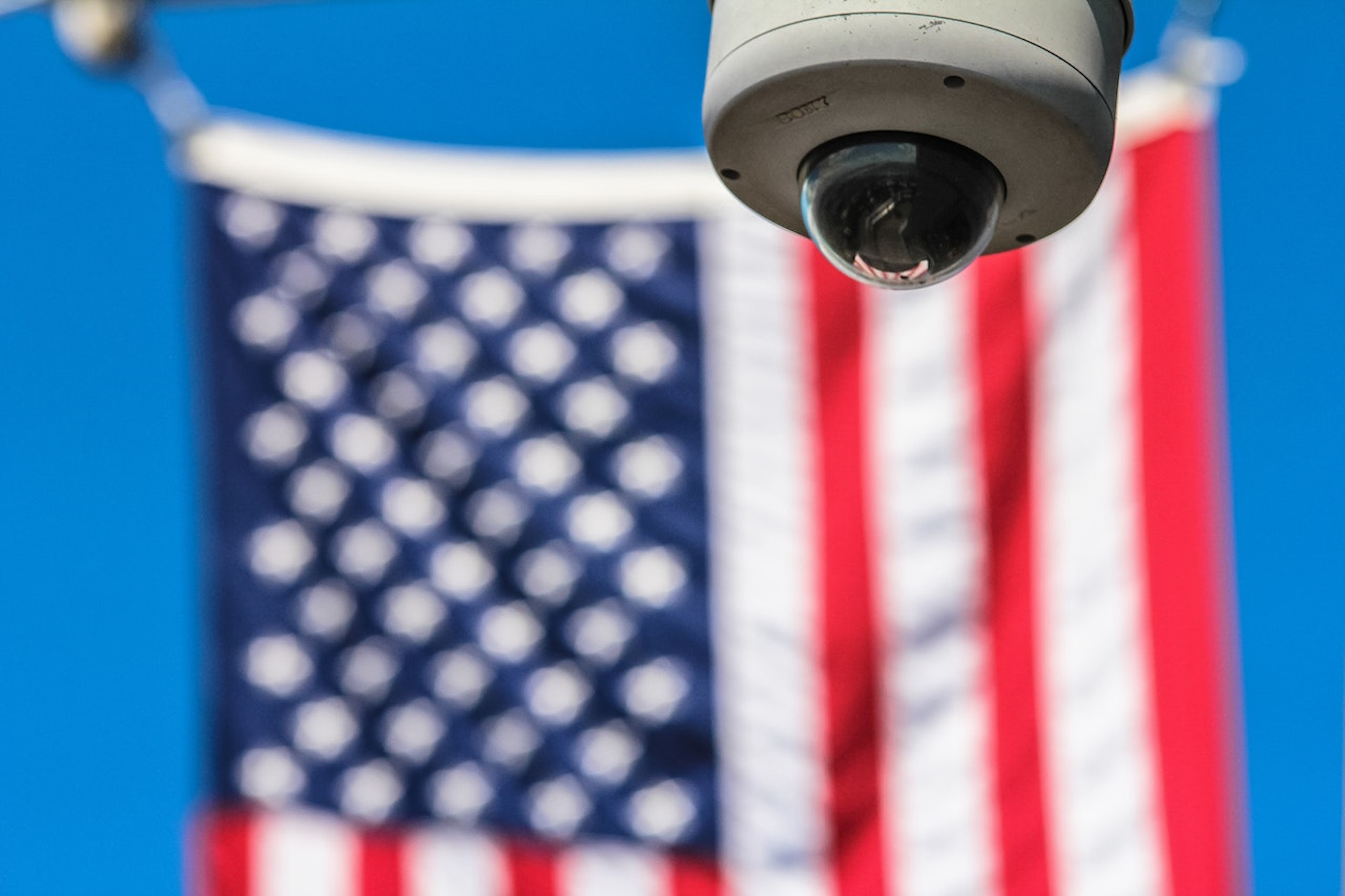 Security camera in front of the US flag