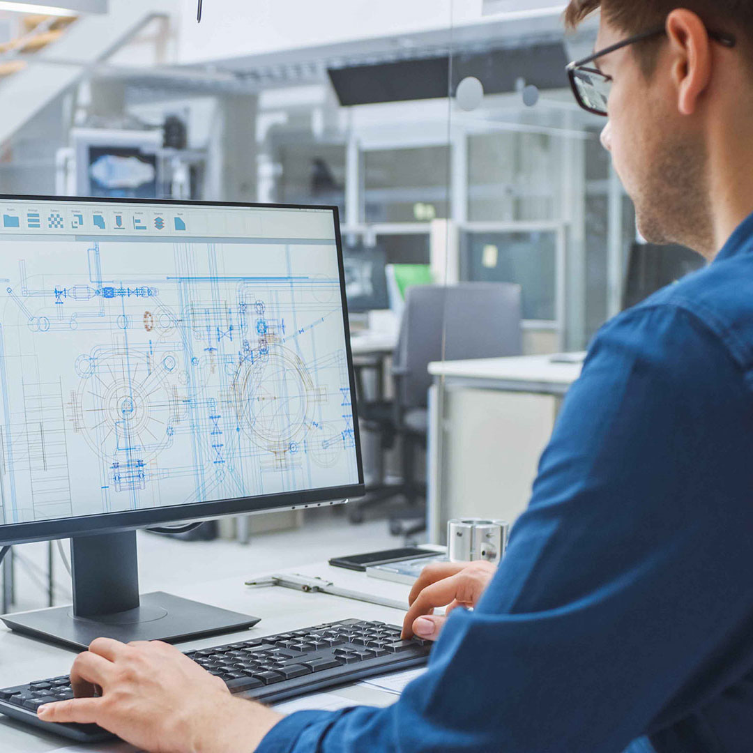 Employee sitting at computer screen in office