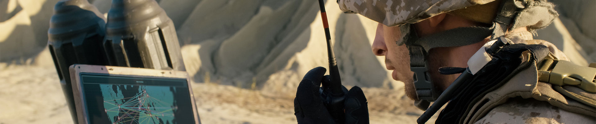 Soldier in combat gear using comms