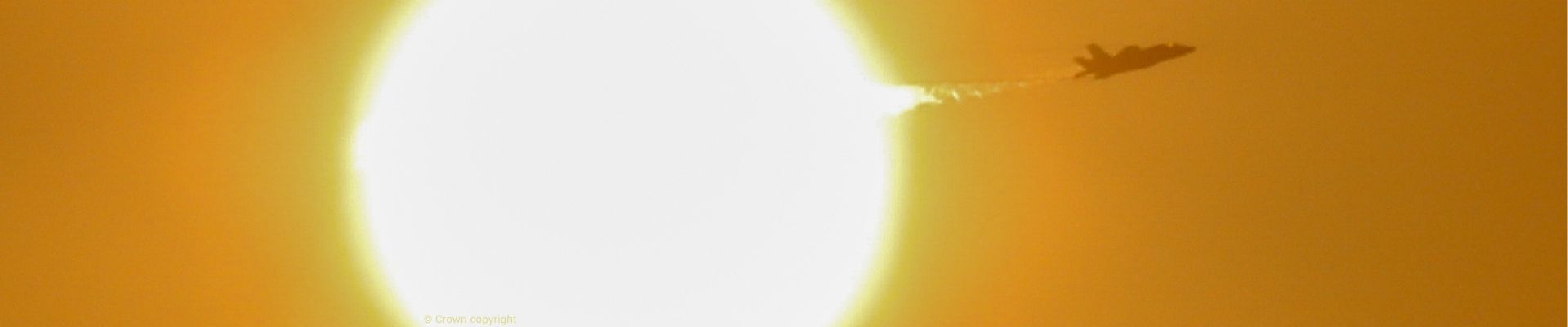 F35B Lightning II flying in front of the sun during developmental trials 