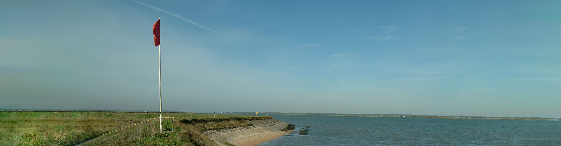Seawall with raised flag at Shoeburyness beach