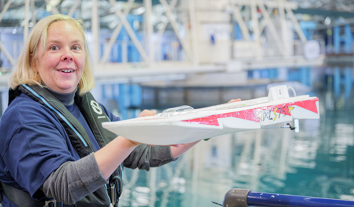 QinetiQ employee holding a boat at Haslar's Ocean Basin