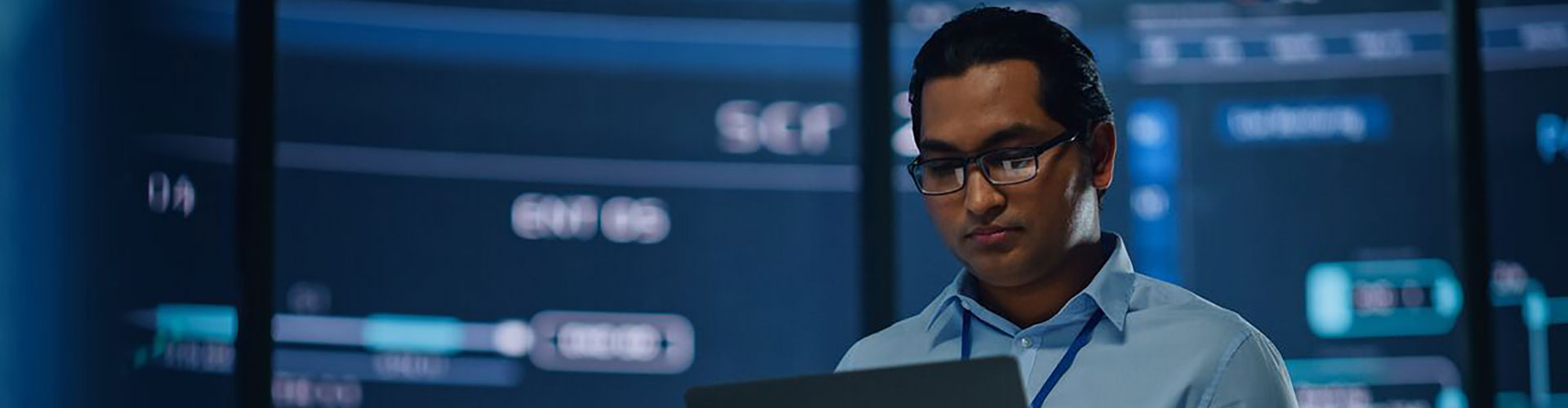 Man looking at laptop with cyber background