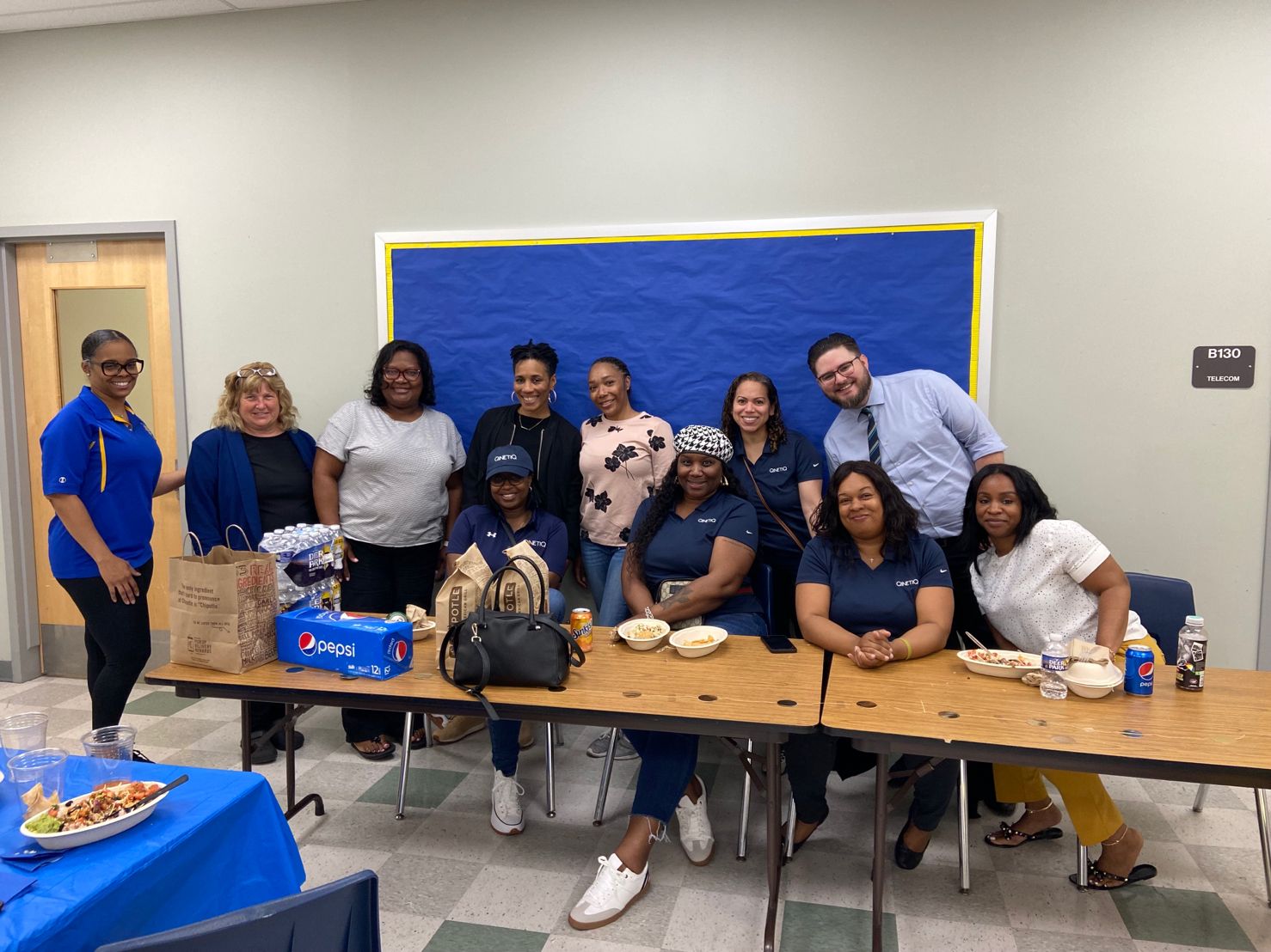 A group photo of QinetiQ US employees at a work event
