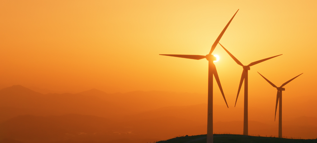 Sustainability Wind farm silhouetted against a sunset Wind farm silhouetted against a sunset