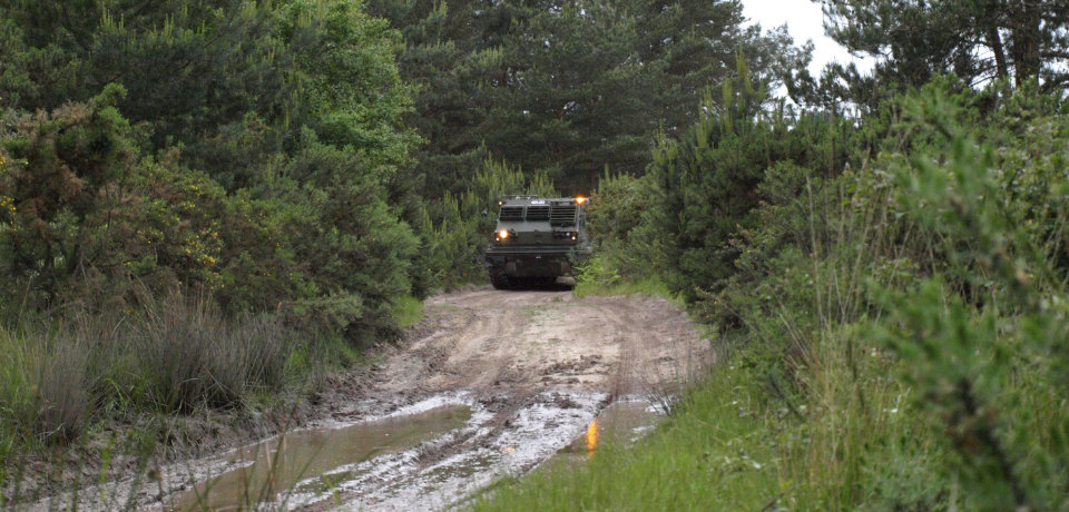 Vehicle carrying out realistic training scenario at Hurn Proving Ground
