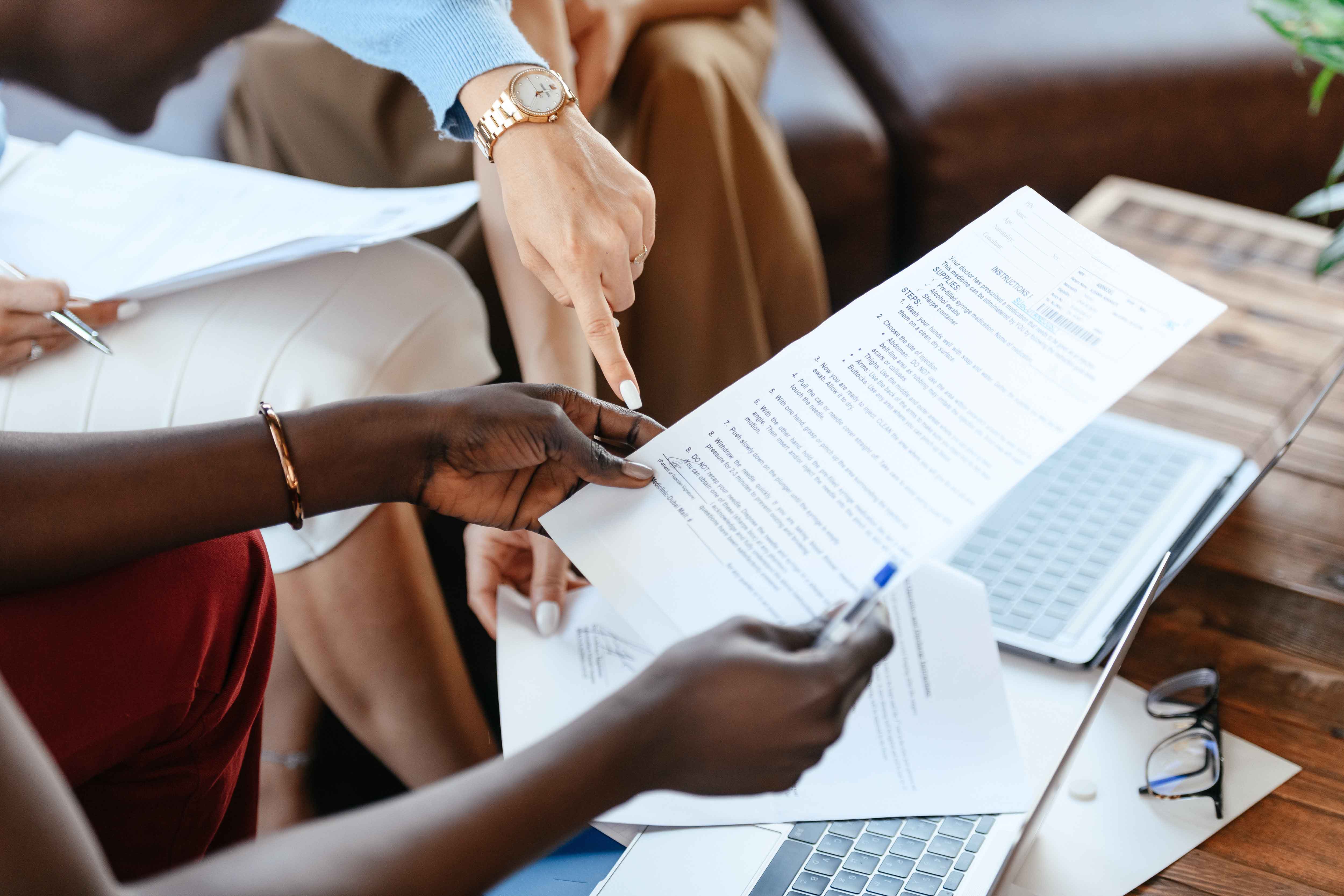 Two Women reading over a contract