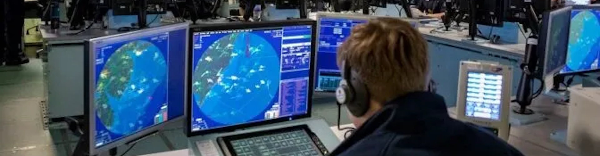 Person looking at monitors that show various points plotted across the globe (Image: Crown Copyright)