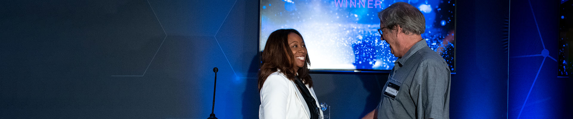 Employee on stage receiving award