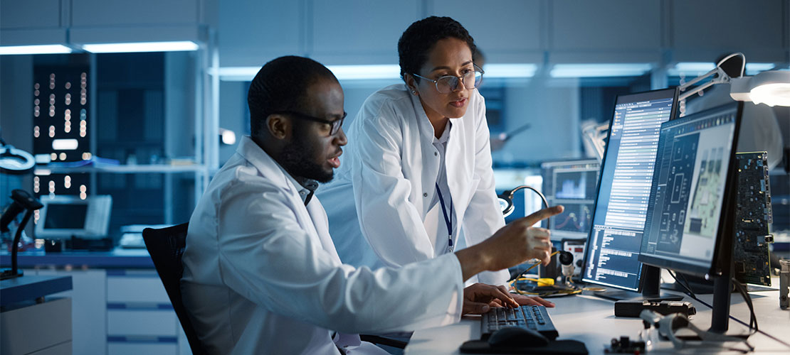 2 researchers looking at computer screens
