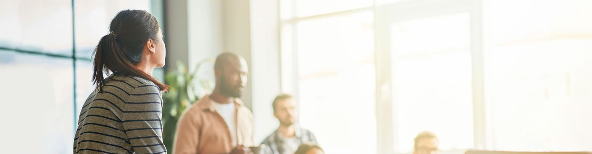 Group of diverse professionals in a modern, open-plan office space