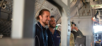 Two QinetiQ Australia employees smiling inside and aircraft