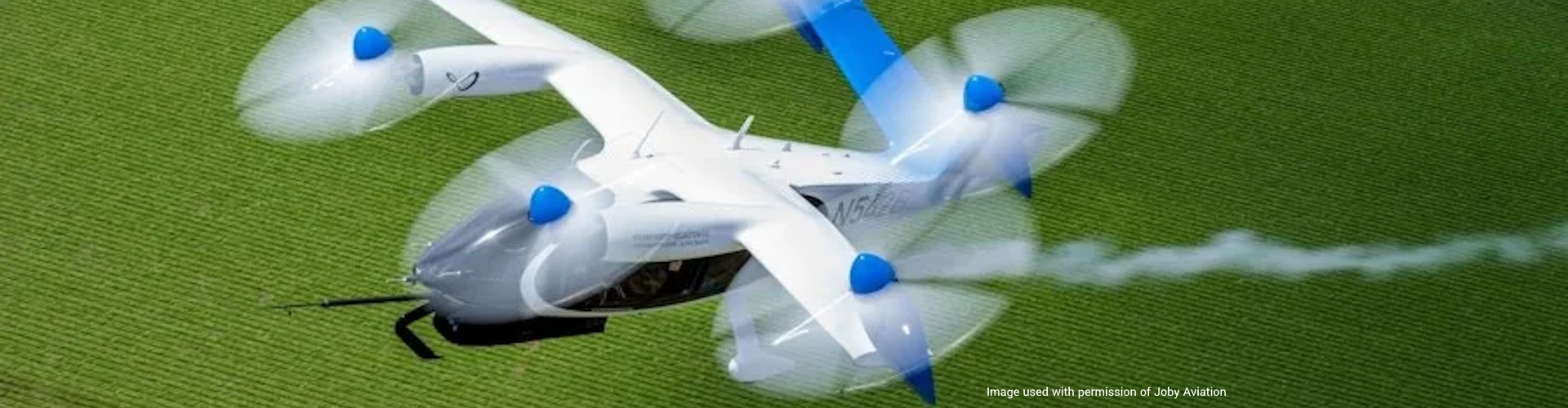 The hydrogen-powered vertical take-off and landing (VTOL) air taxi flying over a field. (Image courtesy of Joby Aviation. © Joby Aero, inc)