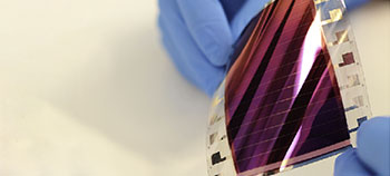 organic solar panel being held between fingers