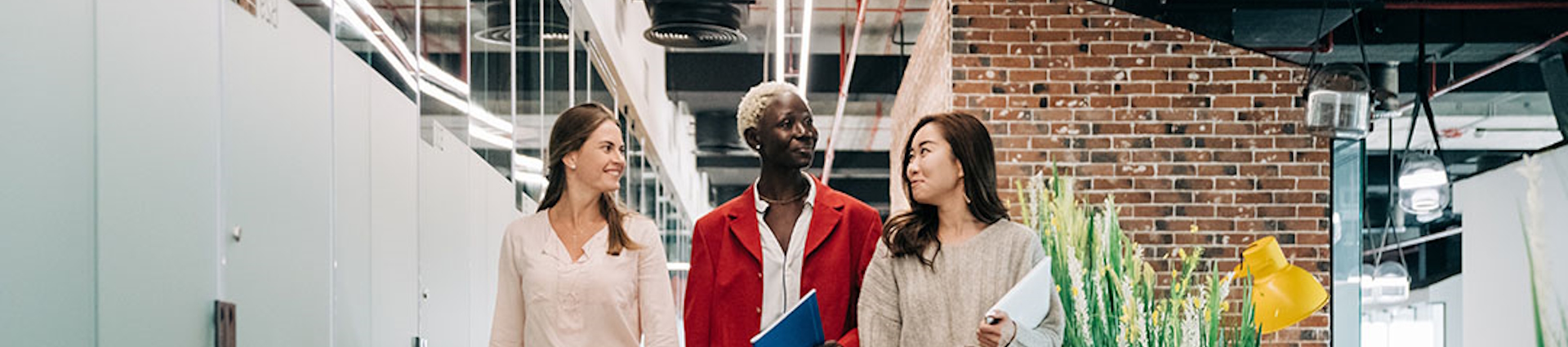 Three people walking through an office